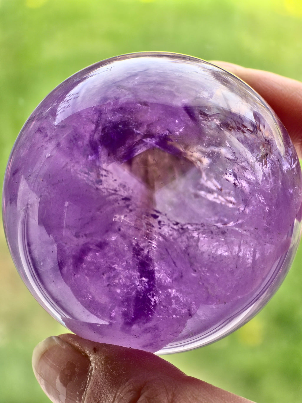 Amethyst sphere with phantom lines and rainbows