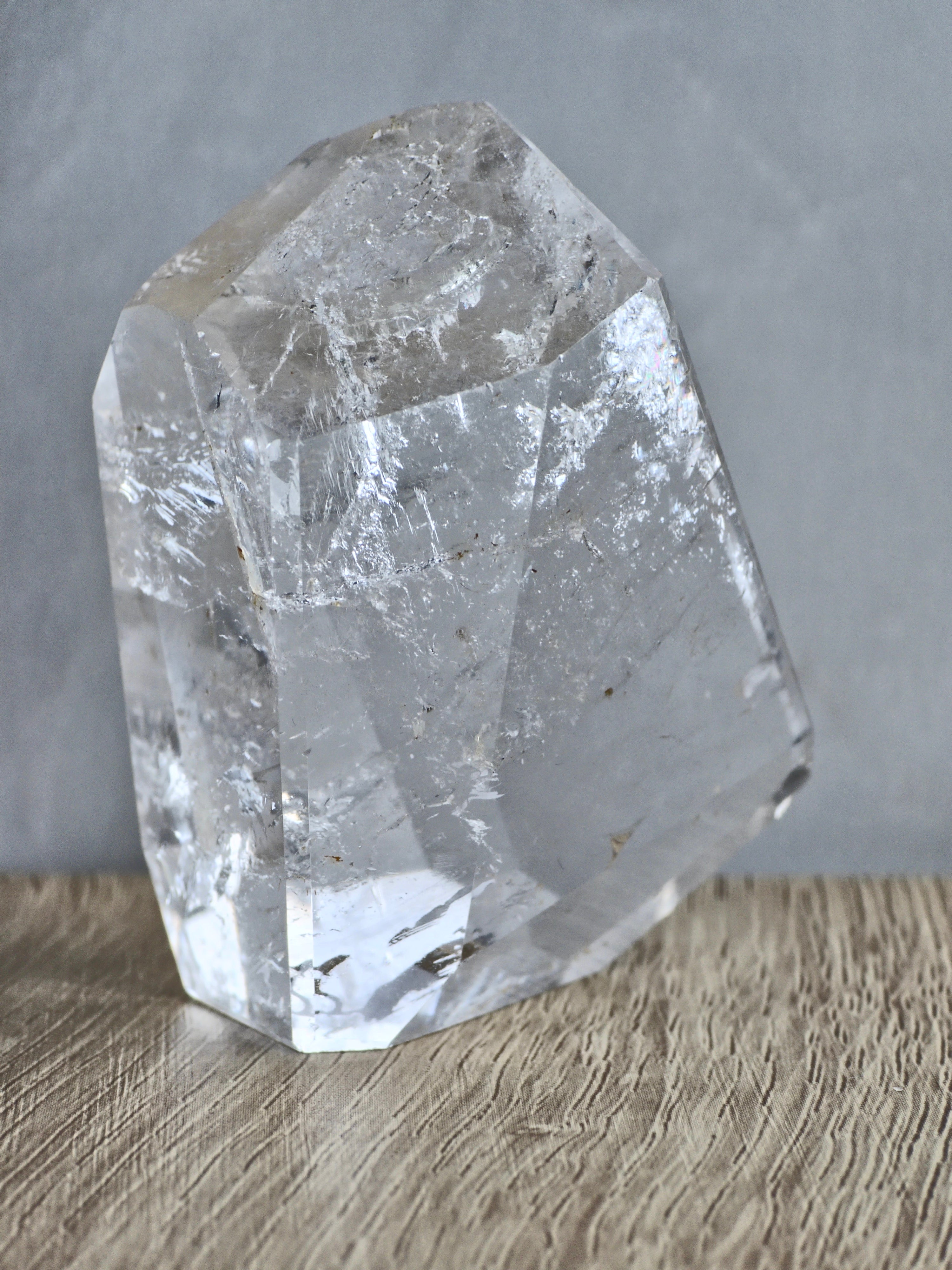 Quartz freeform with iron inclusions and rainbow