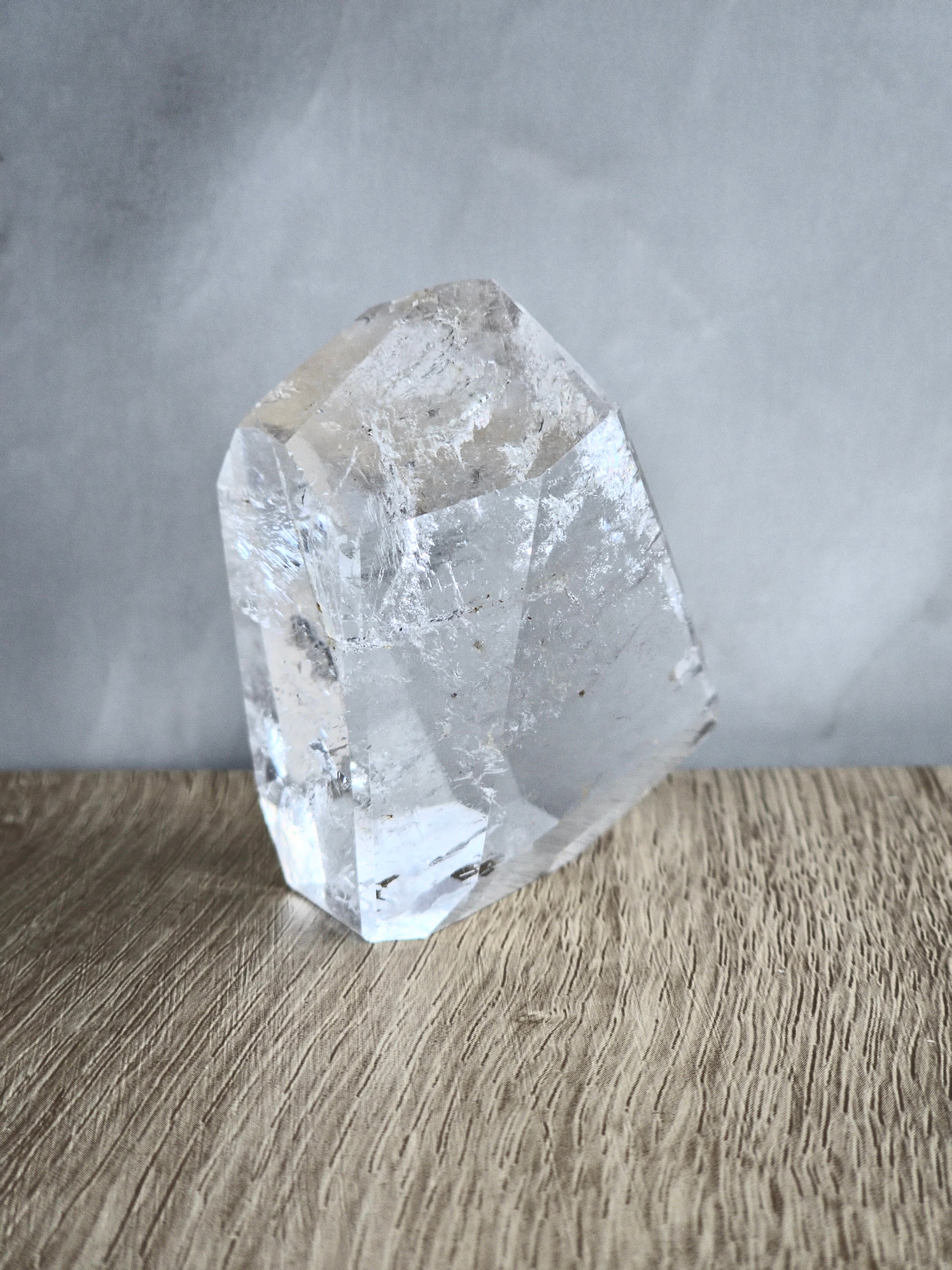 Quartz freeform with iron inclusions and rainbow