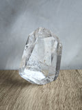 Quartz freeform with iron inclusions and rainbow