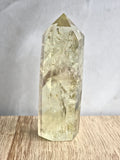 Natural citrine polished point featuring phantom formations and rainbow inclusion