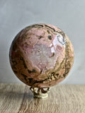 Peruvian Rhodonite Sphere — Pink Manganese Silicate with Quartz Pocket + Manganese Oxide Veining