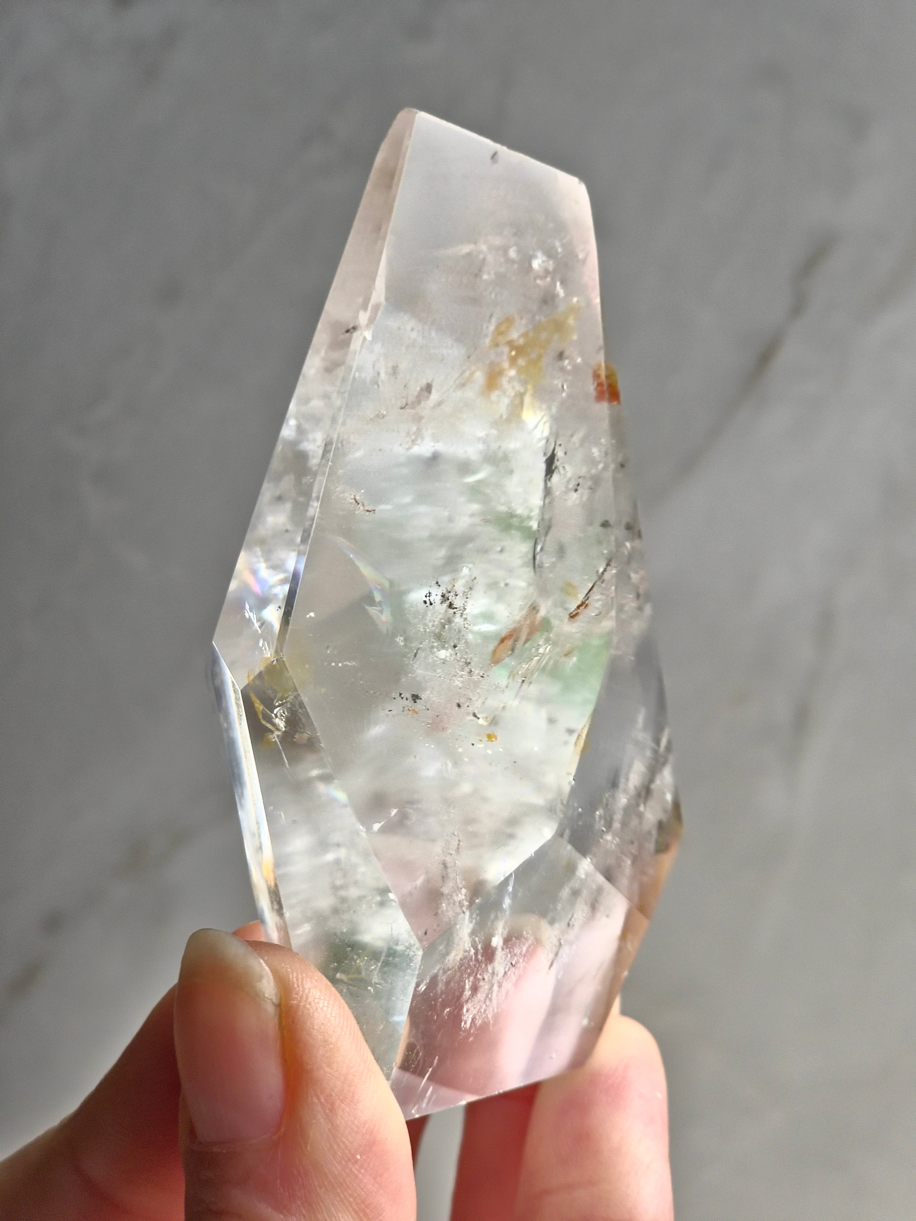 Quartz freeform with iron and chlorite inclusions