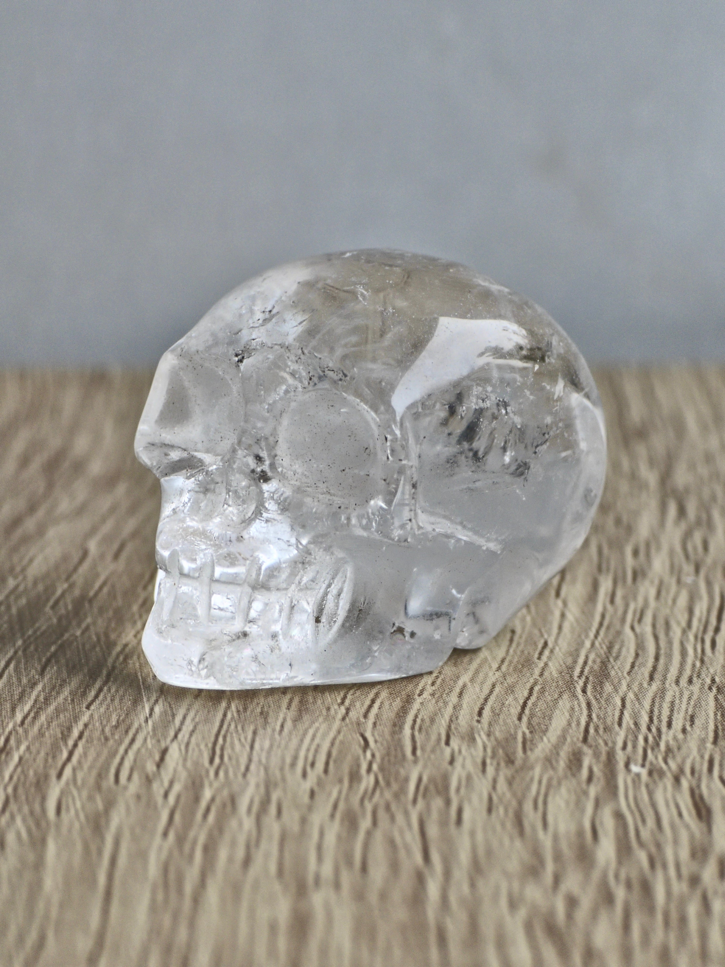 Clear quartz skull with rainbows - b