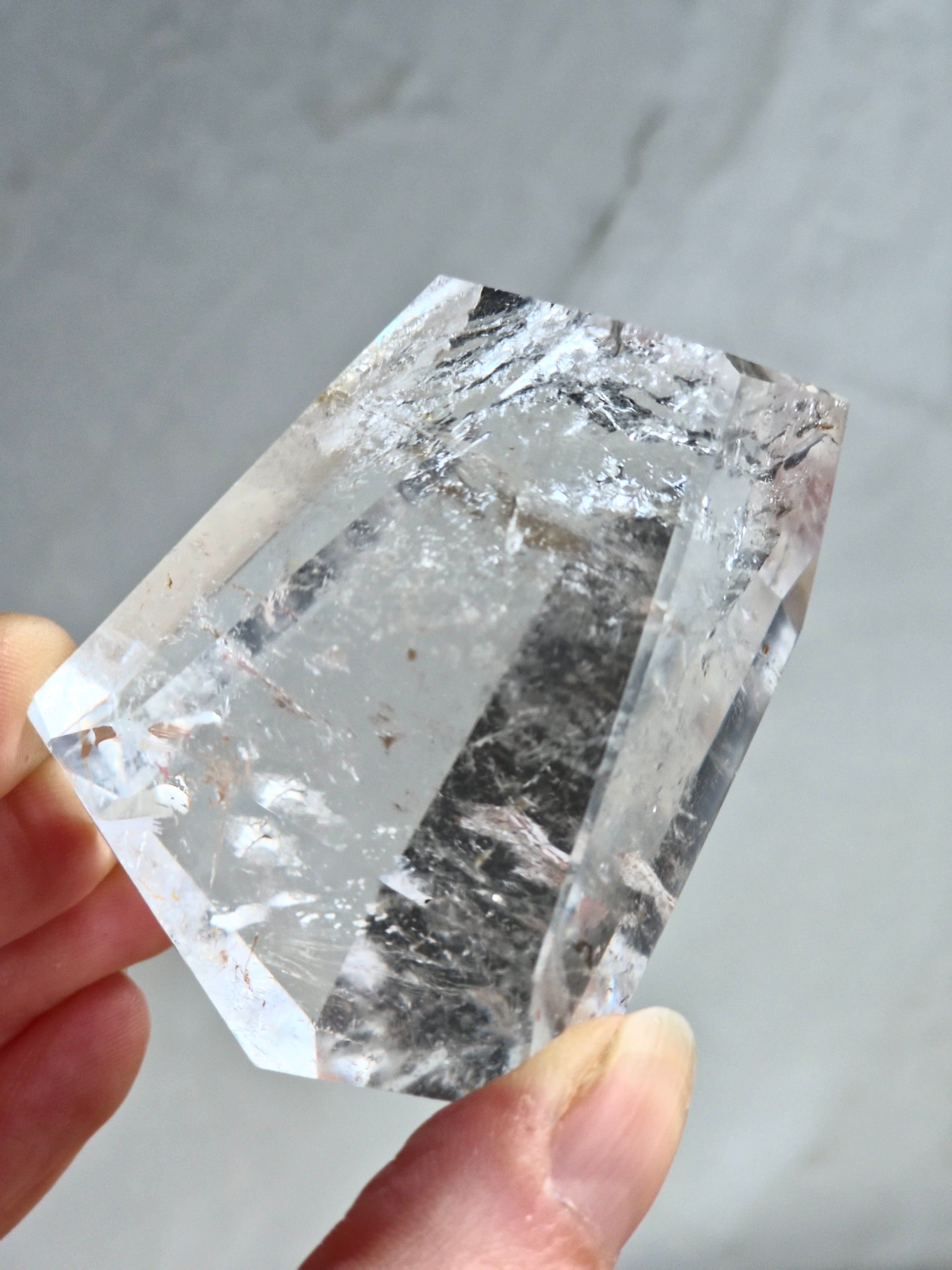 Quartz freeform with iron inclusions and rainbow
