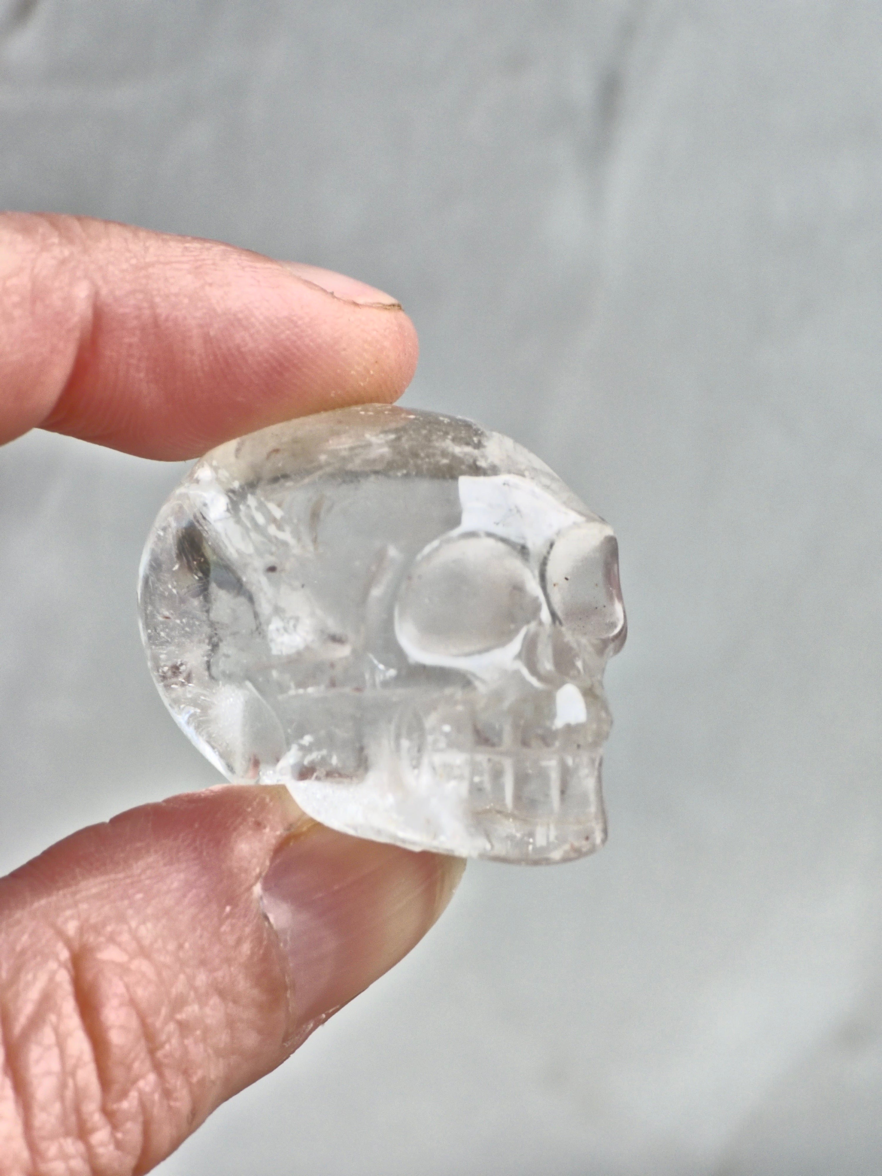 Clear quartz skull with rainbow - c