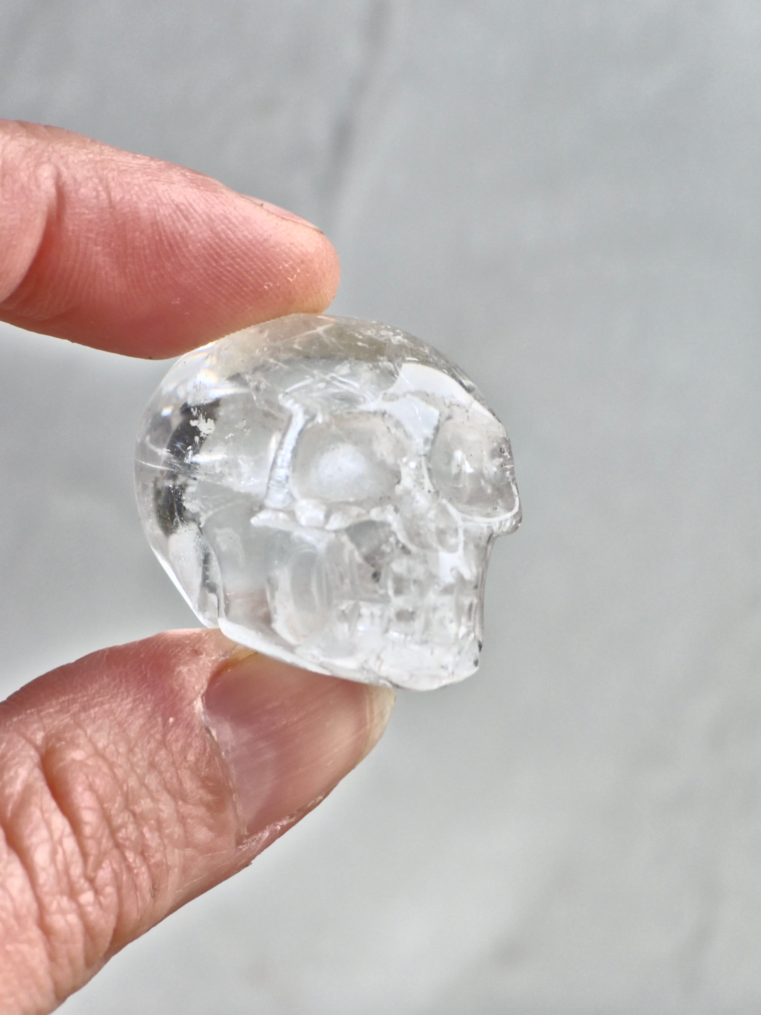 Clear quartz skull with rainbows - b
