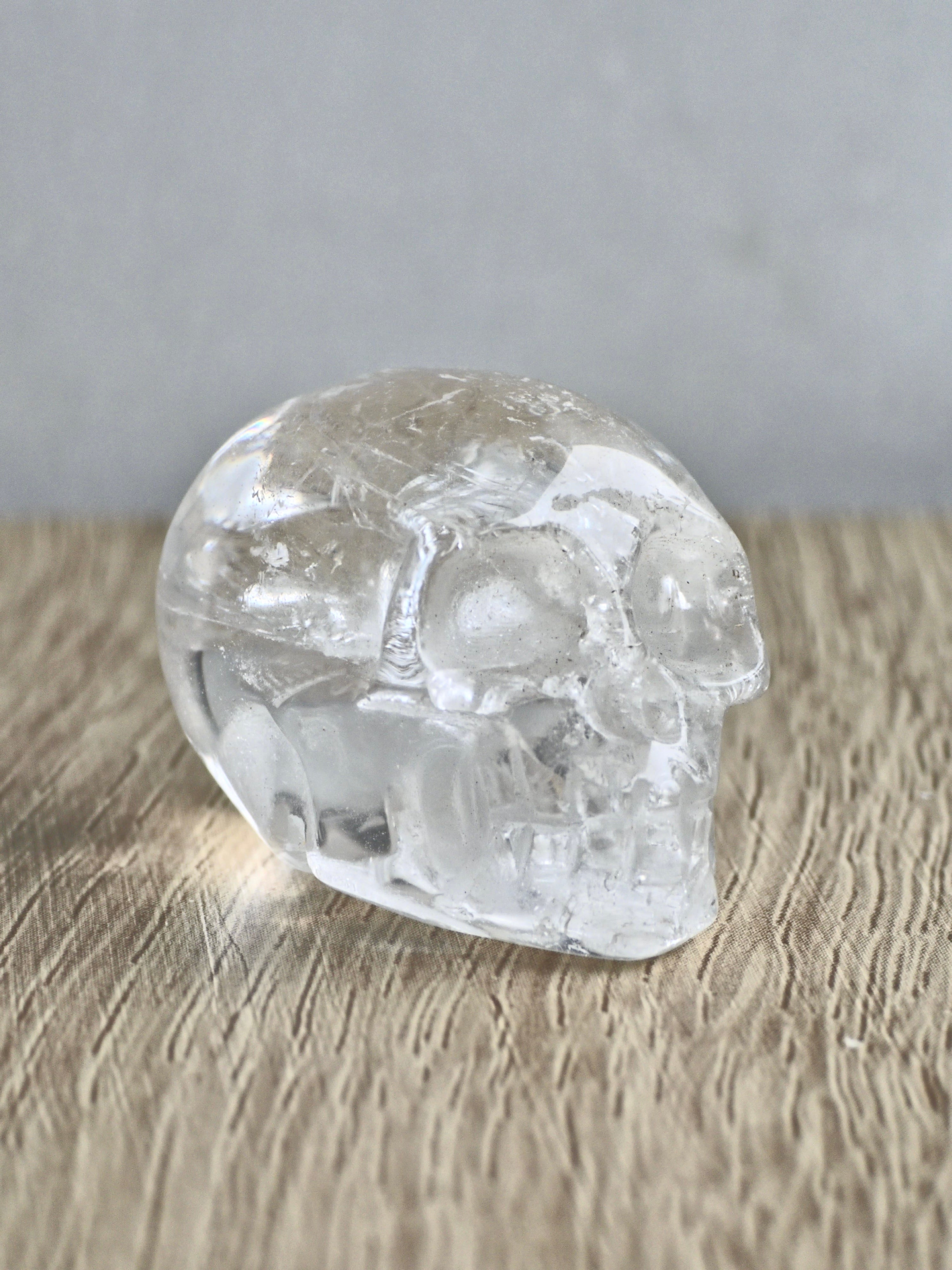 Clear quartz skull with rainbows - b