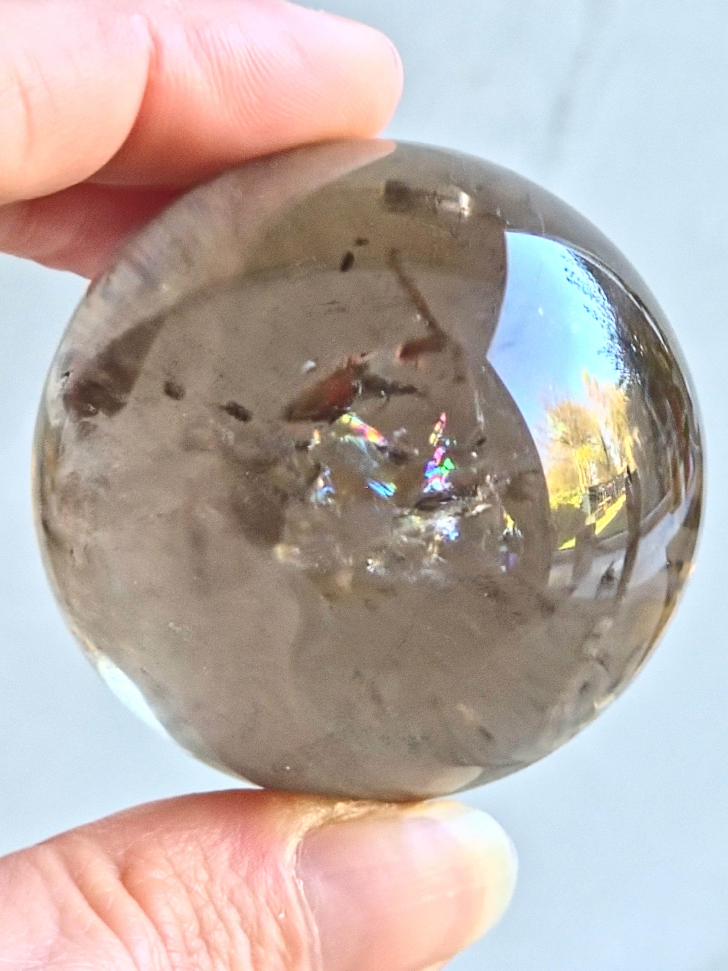 Smoky quartz sphere with rainbows - c