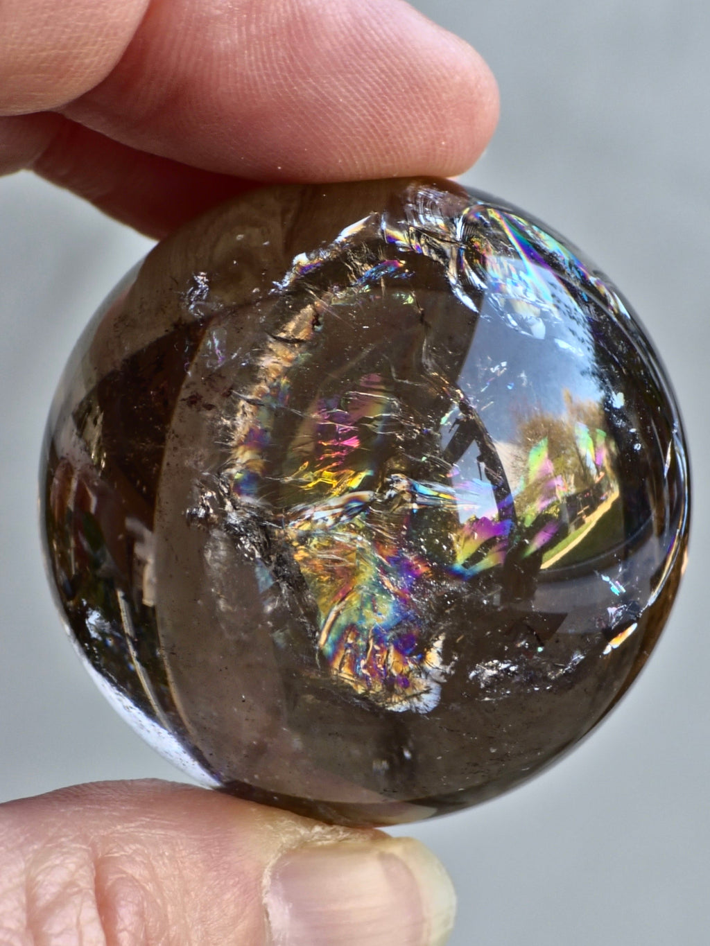 Smokey quartz sphere with rainbows- a