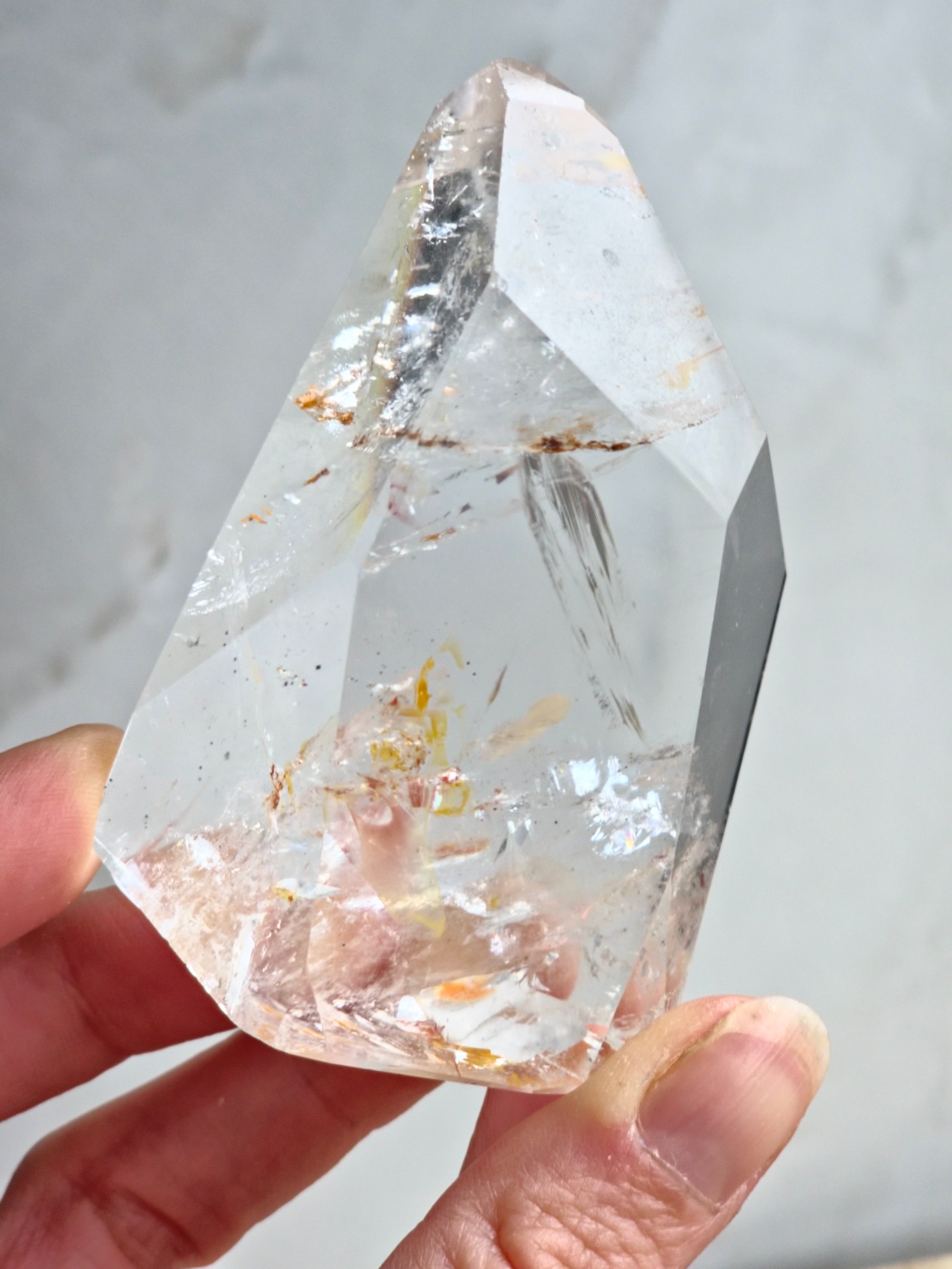 Quartz freeform with iron inclusions and rainbows