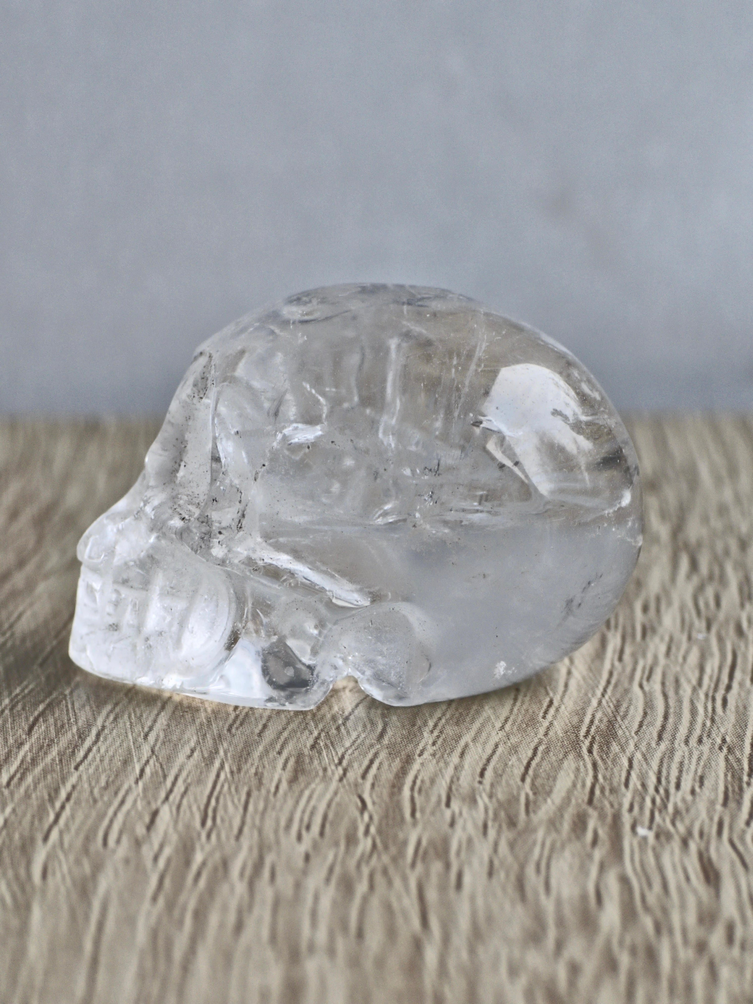 Clear quartz skull with rainbows - b