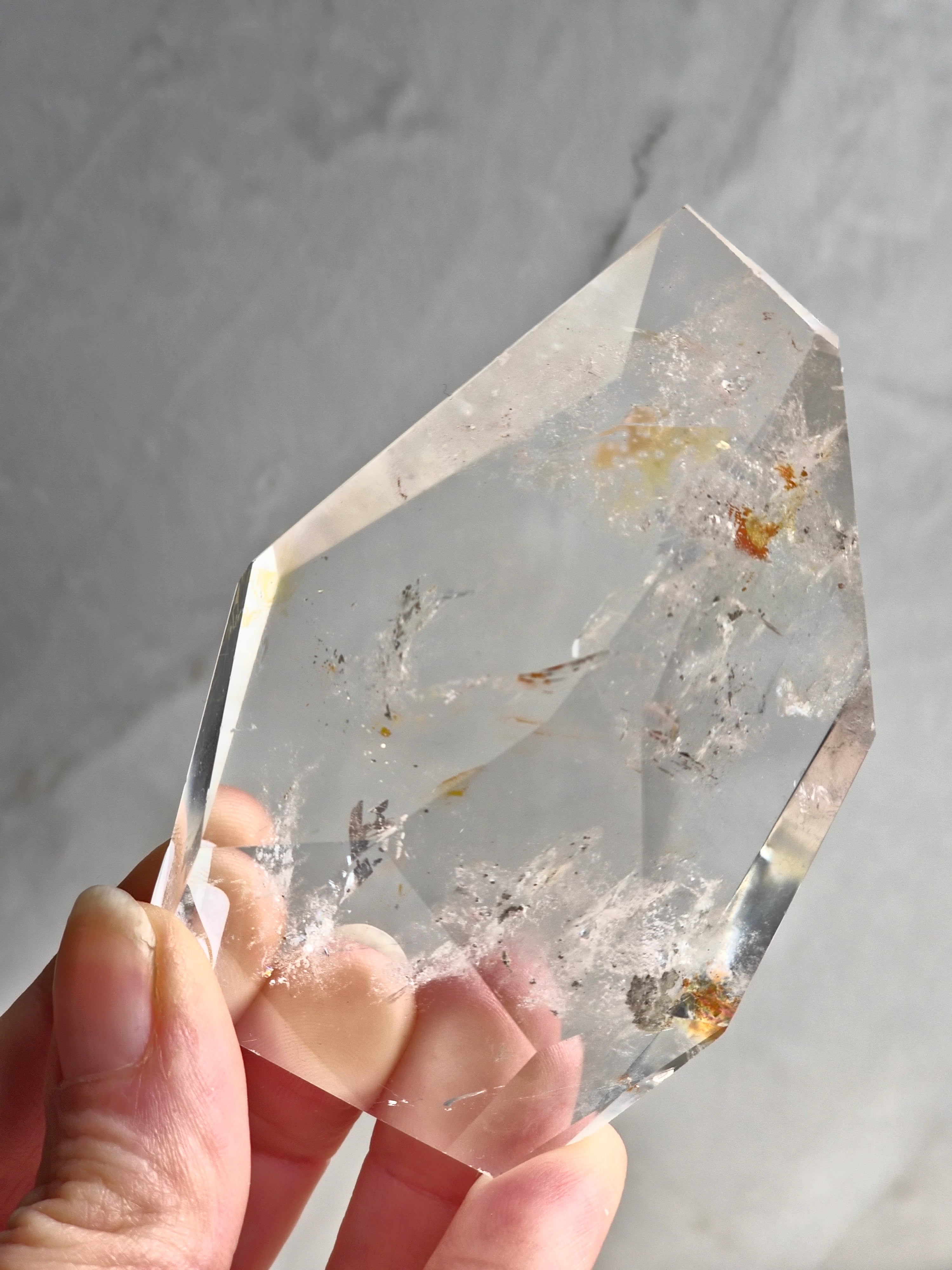 Quartz freeform with iron and chlorite inclusions