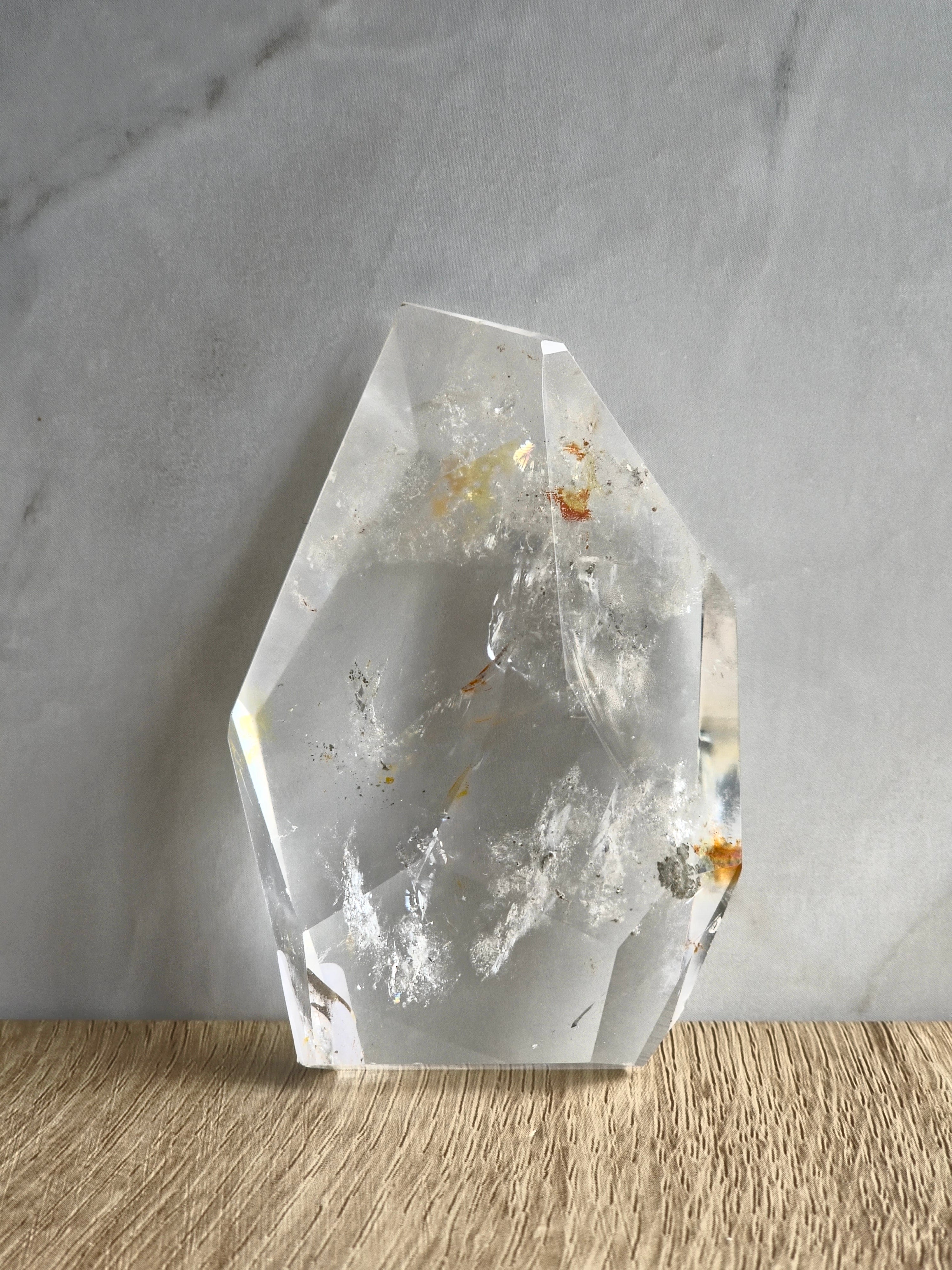 Quartz freeform with iron and chlorite inclusions