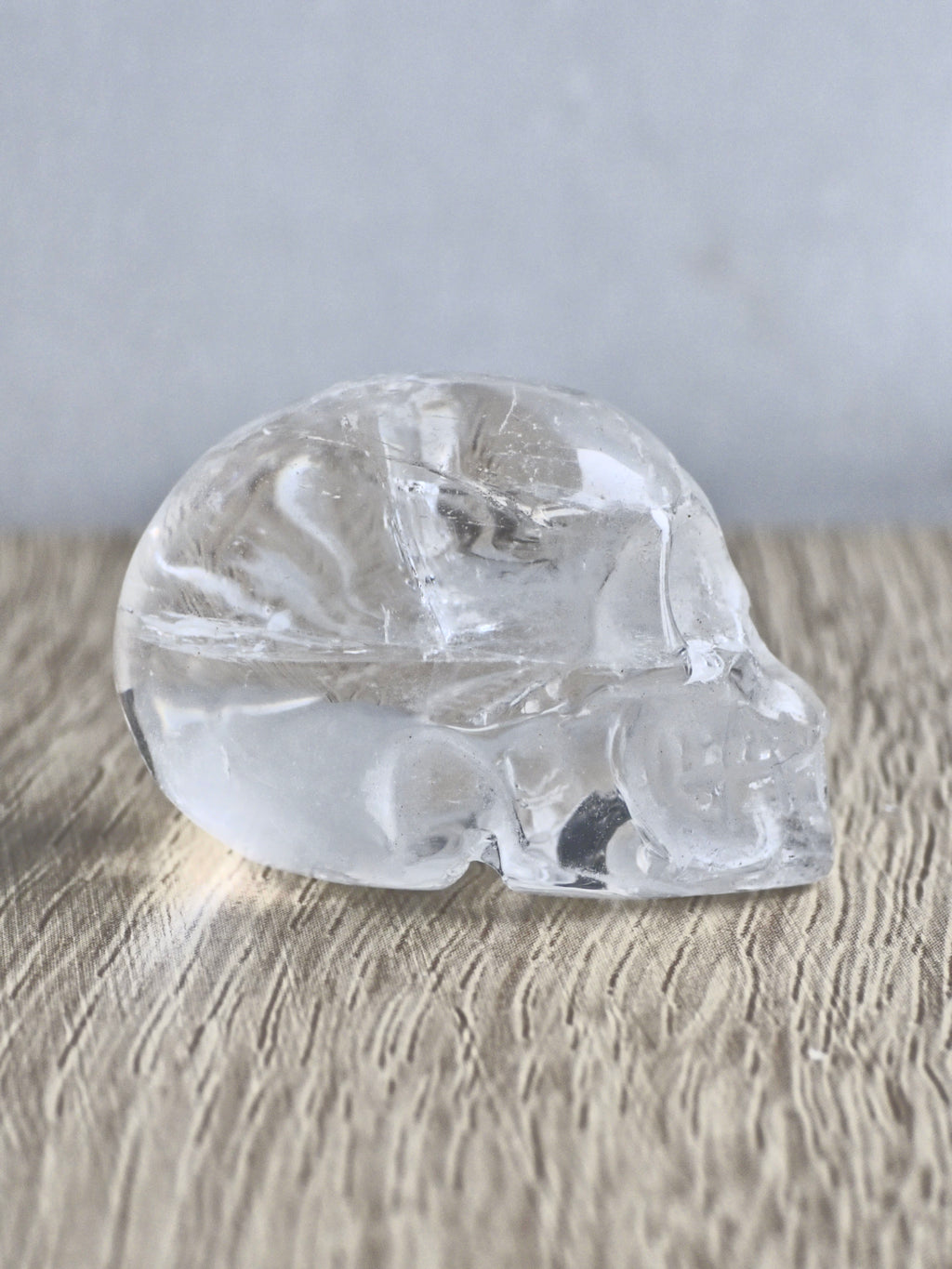 Clear quartz skull with rainbows - b