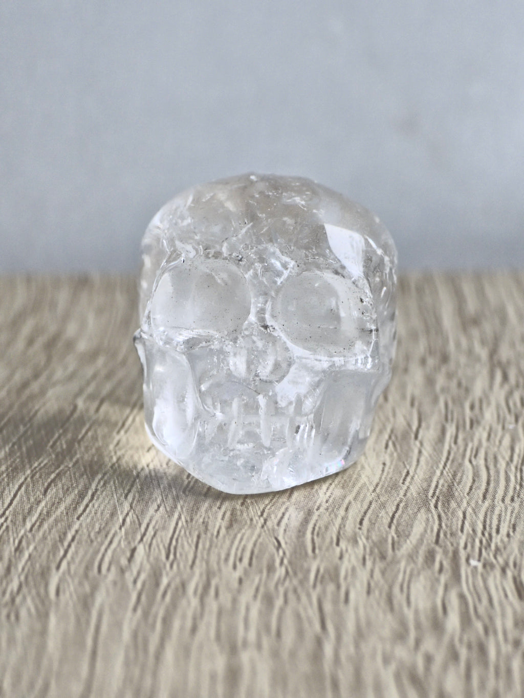 Clear quartz skull with rainbows - b