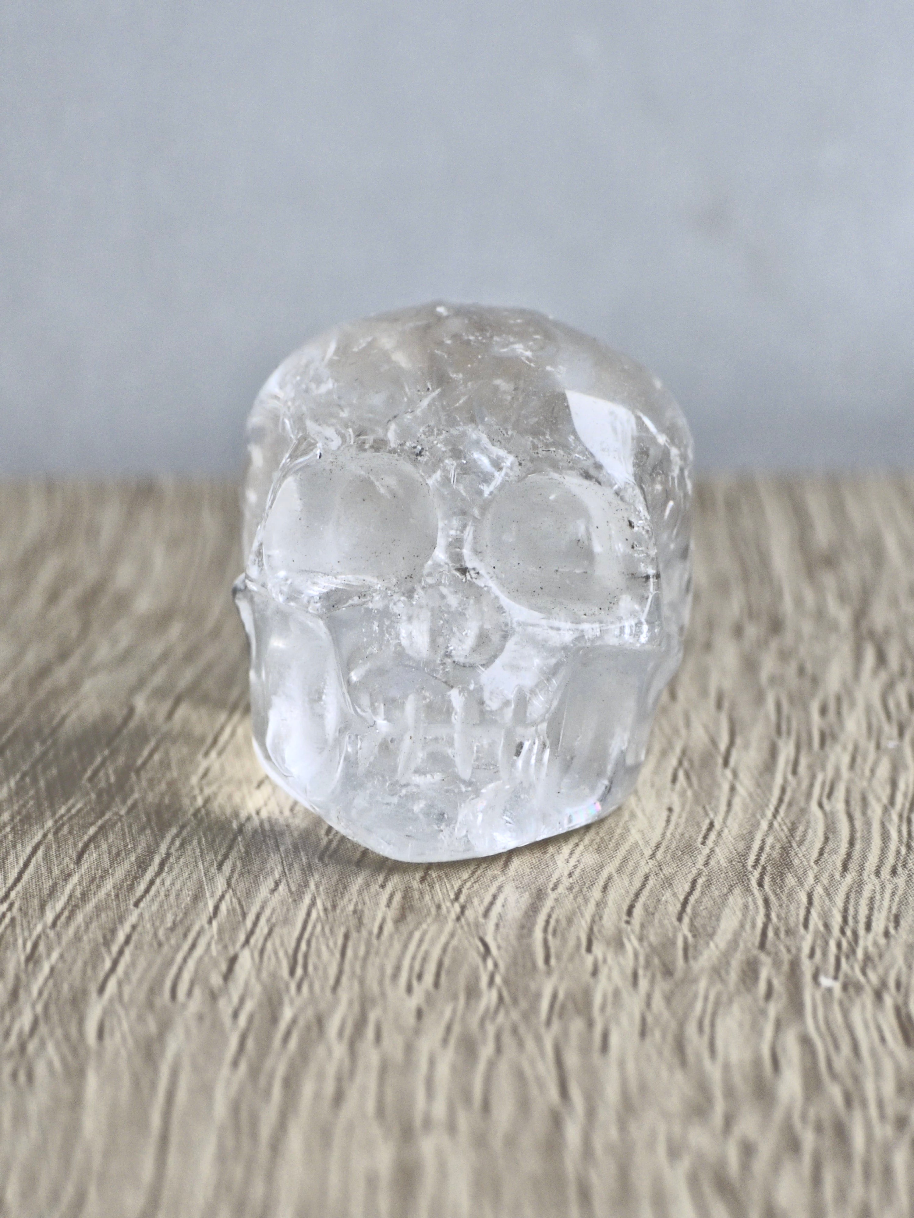 Clear quartz skull with rainbows - b