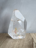 Quartz freeform with iron inclusions and rainbows